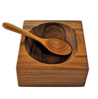 Wooden bowl and spoon set with natural grain patterns.