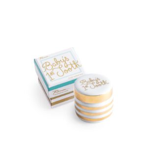Stacked white and gold striped candles with a matching box.