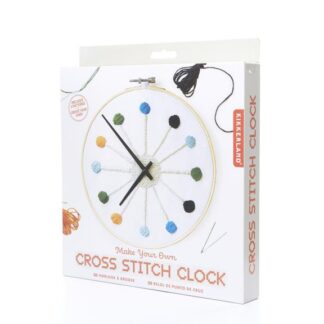 A colorful cross stitch clock kit with thread and needle.