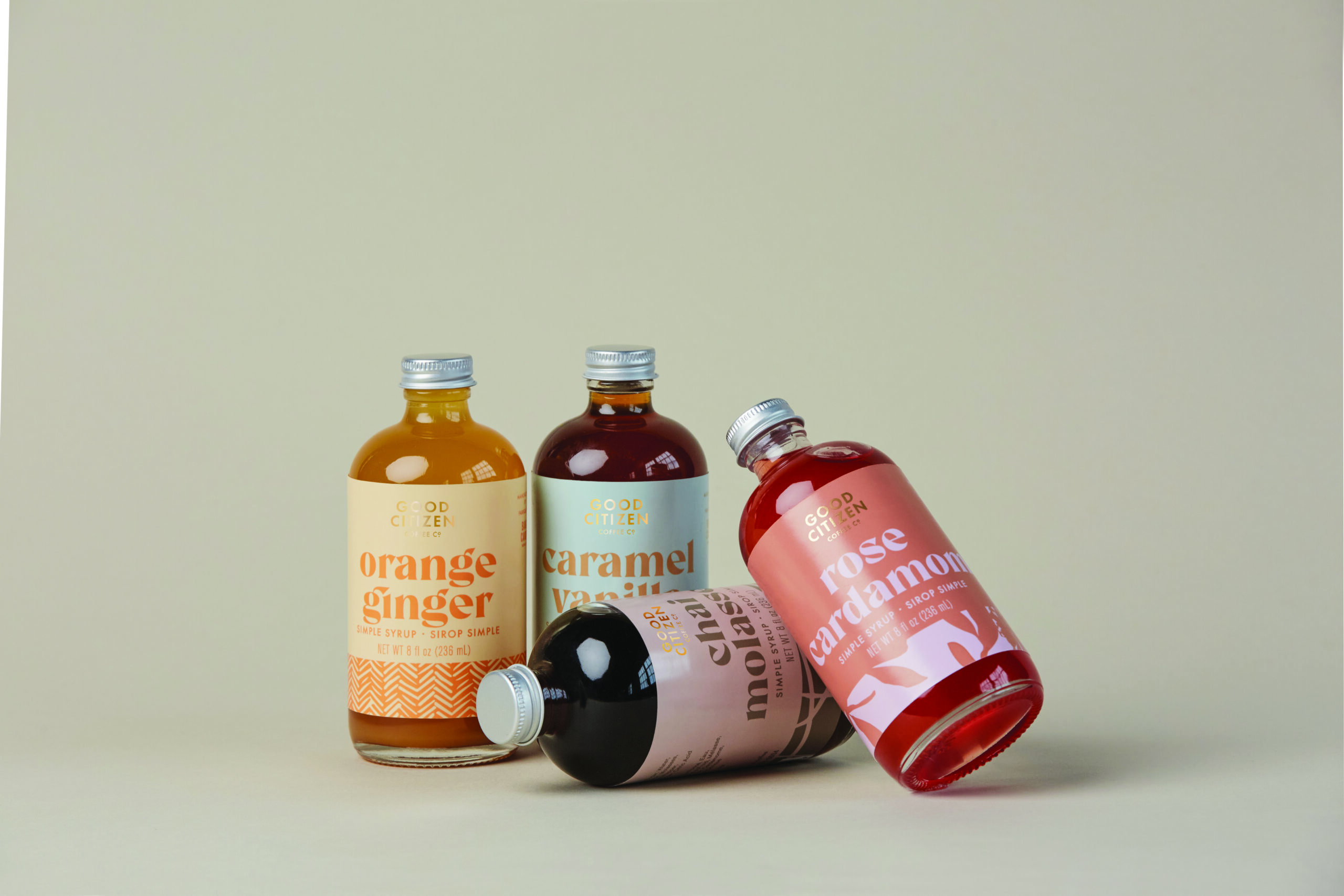 Four colorful syrup bottles from Good Citizen Coffee Co with unique flavors.