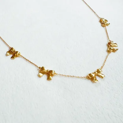 Delicate gold necklace with butterfly charms.