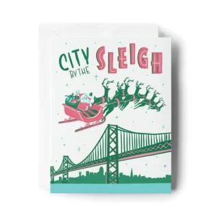 Holiday card with Santa and reindeer over a city bridge.