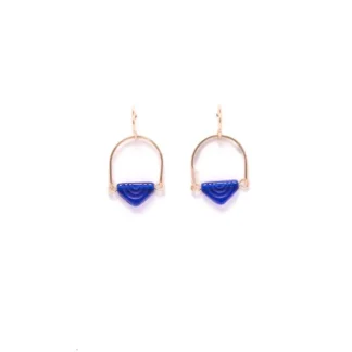 Minimalist gold and blue geometric earrings on white background.