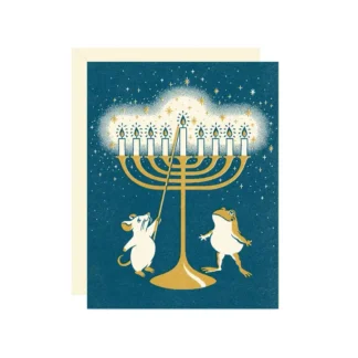 Two mice lighting a golden menorah under a starry night sky.