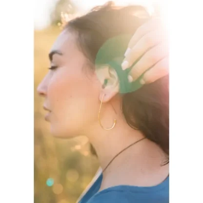 Woman with closed eyes enjoying sunlight and nature.